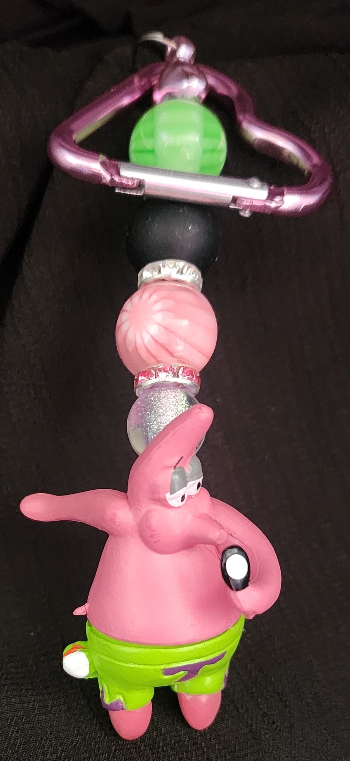 Patrick looking in a mirror keychain